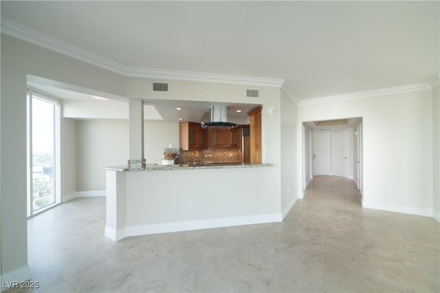 2777 Paradise Rd Unit 1505, Las Vegas, NV 89109 - kitchen featuring crown molding, plenty of natural light, brown cabinetry, backsplash, and baseboards