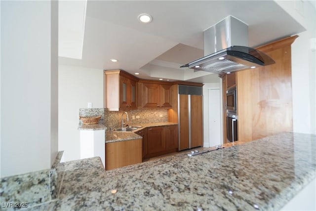 2777 Paradise Rd Unit 1505, Las Vegas, NV 89109 - kitchen with island range hood, a sink, built in appliances, light stone counters, and decorative backsplash