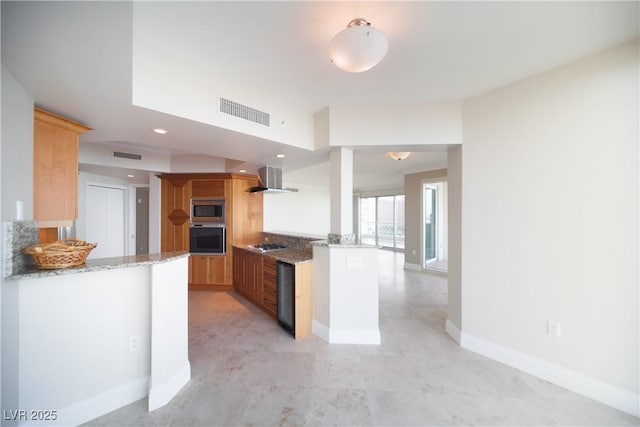 2777 Paradise Rd Unit 1505, Las Vegas, NV 89109 - kitchen with stainless steel appliances, light stone counters, baseboards, wine cooler, and a peninsula