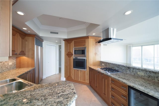 2777 Paradise Rd Unit 1505, Las Vegas, NV 89109 - kitchen featuring built in appliances, island exhaust hood, recessed lighting, ornamental molding, and decorative backsplash