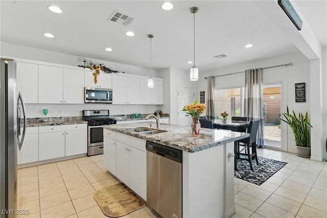 6322 Angora Peak Ln, Las Vegas, NV 89115 - kitchen with appliances with stainless steel finishes, a sink, light tile patterned flooring, white cabinetry, and recessed lighting