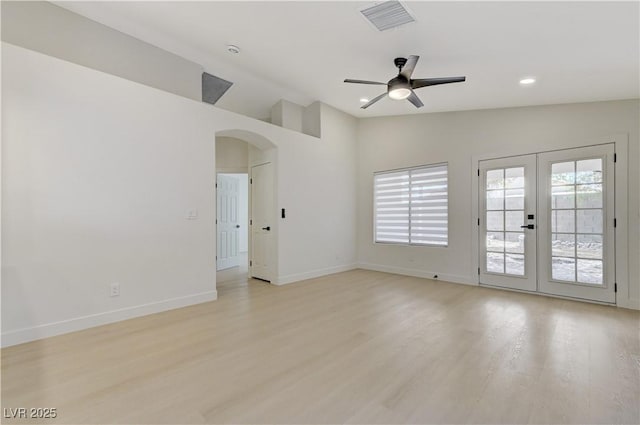 7865 March Brown Ave, Las Vegas, NV 89149 - spare room with arched walkways, vaulted ceiling, light wood finished floors, a ceiling fan, and french doors