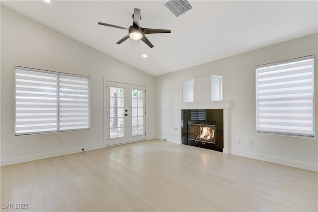 7865 March Brown Ave, Las Vegas, NV 89149 - unfurnished living room with a ceiling fan, vaulted ceiling, a tile fireplace, wood finished floors, and baseboards