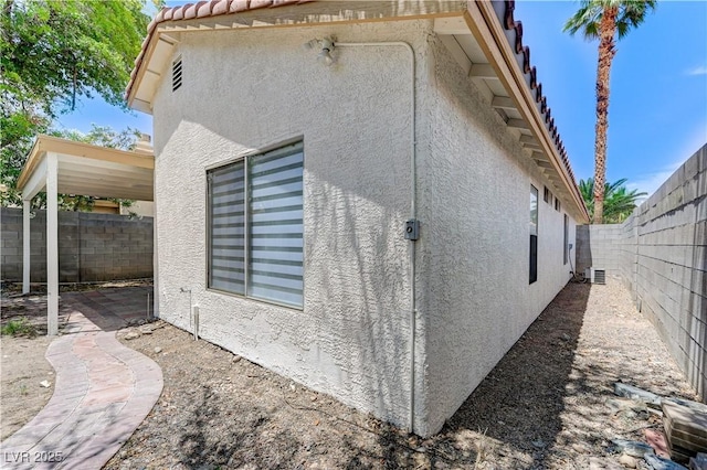 7865 March Brown Ave, Las Vegas, NV 89149 - view of side of property with stucco siding, a fenced backyard, a tiled roof, and a patio