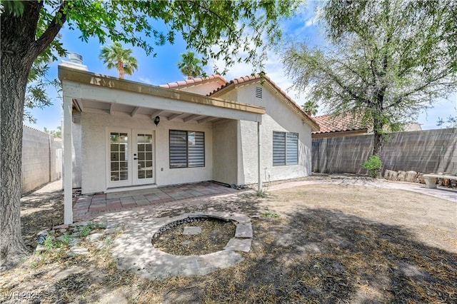 7865 March Brown Ave, Las Vegas, NV 89149 - rear view of house featuring french doors, a tiled roof, stucco siding, and a fenced backyard