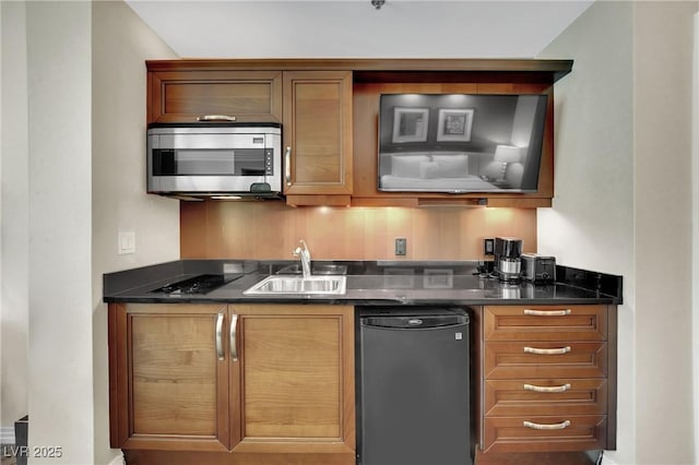 135 E Harmon Ave Unit 315, Las Vegas, NV 89109 - kitchen with stainless steel microwave, dark countertops, and black cooktop