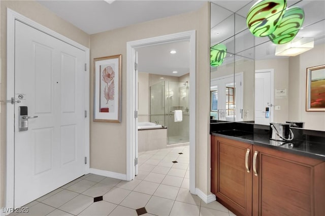 135 E Harmon Ave Unit 315, Las Vegas, NV 89109 - full bath with vanity, a shower stall, a bath, baseboards, and tile patterned floors
