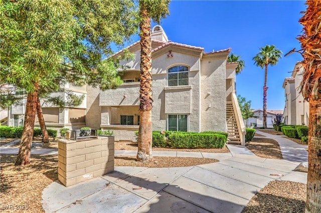 6480 Annie Oakley Dr Unit 624, Las Vegas, NV 89120 - view of front of home featuring stucco siding and stairs