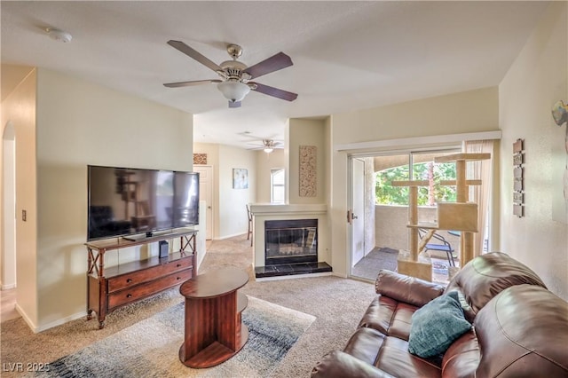 6480 Annie Oakley Dr Unit 624, Las Vegas, NV 89120 - carpeted living room with ceiling fan, baseboards, and a glass covered fireplace