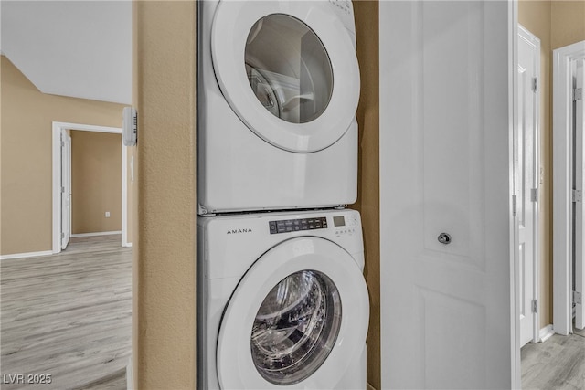 3544 Desert Cliff St Unit 102, Las Vegas, NV 89129 - laundry area with stacked washer / drying machine, light wood finished floors, and baseboards