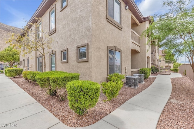 3544 Desert Cliff St Unit 102, Las Vegas, NV 89129 - view of side of home with stucco siding and central AC unit