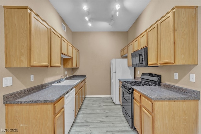 3544 Desert Cliff St Unit 102, Las Vegas, NV 89129 - kitchen with black appliances, a sink, light brown cabinets, and light wood-type flooring