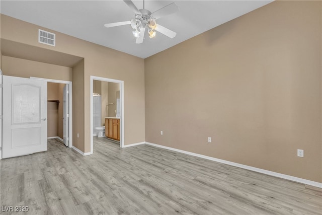 3544 Desert Cliff St Unit 102, Las Vegas, NV 89129 - unfurnished bedroom with light wood-style flooring, a spacious closet, baseboards, a closet, and connected bathroom