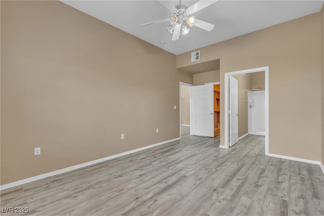 3544 Desert Cliff St Unit 102, Las Vegas, NV 89129 - empty room with baseboards, light wood-type flooring, a ceiling fan, and a high ceiling