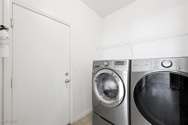 9104 Ashiwi Ave, Las Vegas, NV 89178 - laundry area with washer and dryer, light tile patterned floors, and baseboards