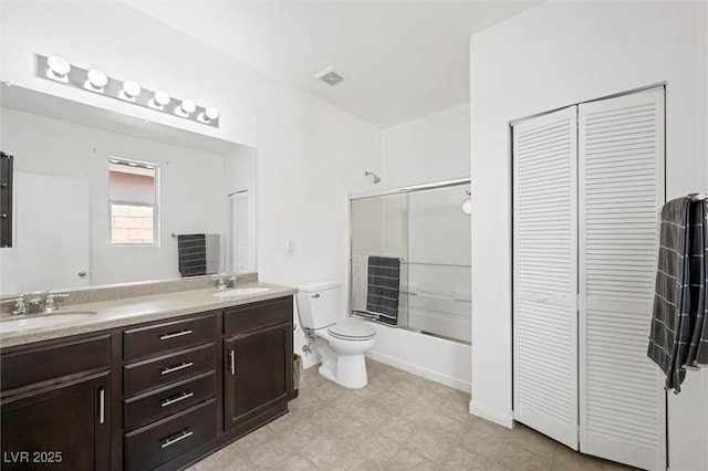 9104 Ashiwi Ave, Las Vegas, NV 89178 - full bathroom featuring a closet, double vanity, toilet, and shower / bath combination with glass door