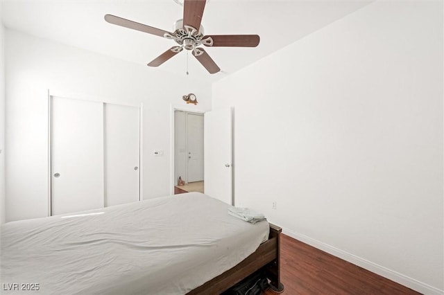 9104 Ashiwi Ave, Las Vegas, NV 89178 - bedroom with baseboards, wood finished floors, a closet, and a ceiling fan