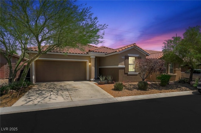 9104 Ashiwi Ave, Las Vegas, NV 89178 - mediterranean / spanish-style home featuring stucco siding, a garage, a tile roof, and concrete driveway