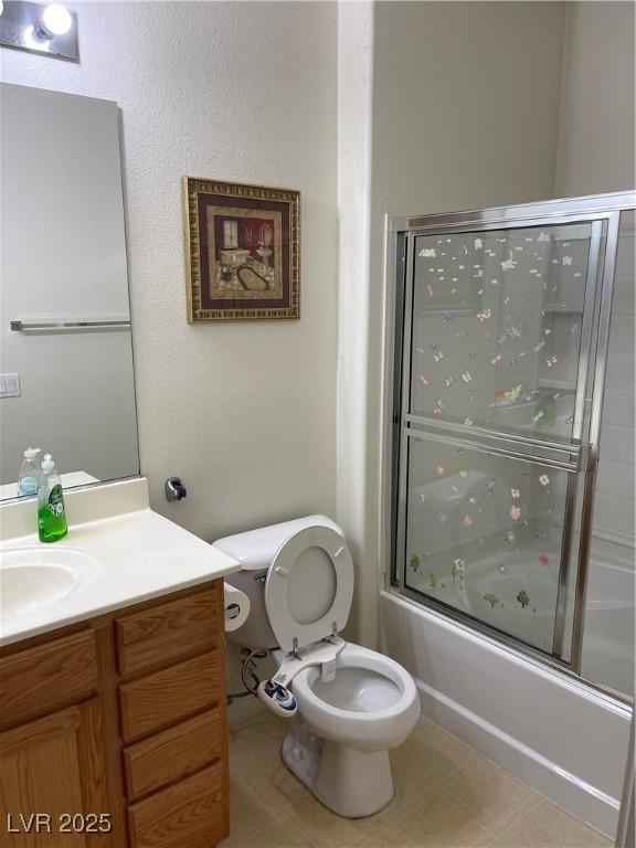 5334 Floating Flower Ave, Las Vegas, NV 89139 - bathroom featuring vanity, enclosed tub / shower combo, and toilet