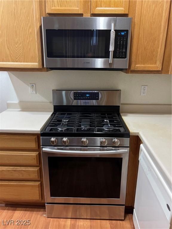 5334 Floating Flower Ave, Las Vegas, NV 89139 - kitchen with appliances with stainless steel finishes, light countertops, and light wood-type flooring