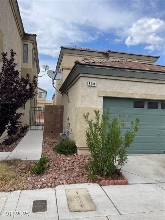 5334 Floating Flower Ave, Las Vegas, NV 89139 - view of side of home with stucco siding and a gate