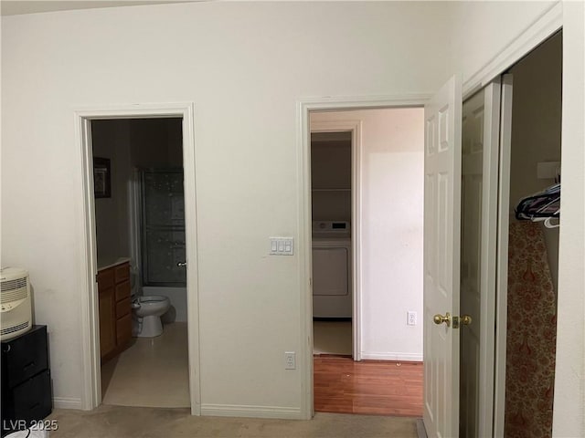 5334 Floating Flower Ave, Las Vegas, NV 89139 - bedroom featuring washer / clothes dryer, ensuite bathroom, baseboards, and a closet