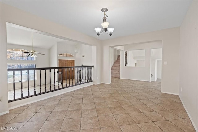 2812 Via Avanti St, Henderson, NV 89074 - tiled spare room with a chandelier, ceiling fan, baseboards, and stairway