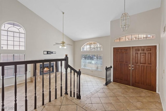 2812 Via Avanti St, Henderson, NV 89074 - entrance foyer with high vaulted ceiling, light tile patterned flooring, ceiling fan, and baseboards
