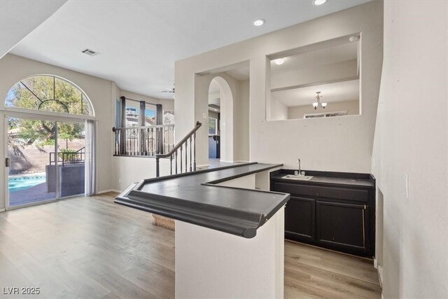 2812 Via Avanti St, Henderson, NV 89074 - kitchen featuring a sink, light wood-style flooring, dark countertops, recessed lighting, and baseboards