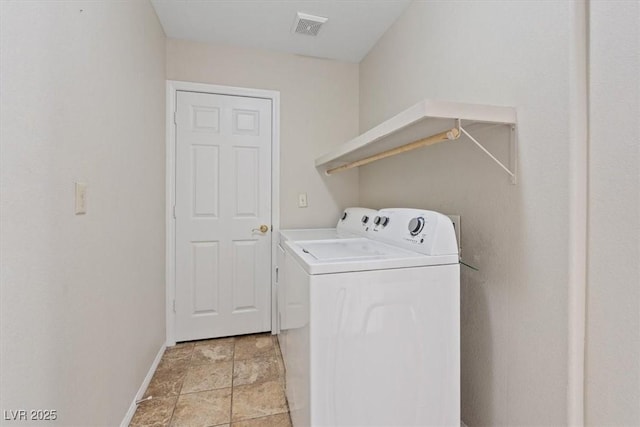 2812 Via Avanti St, Henderson, NV 89074 - laundry area with washing machine and dryer, baseboards, and light stone finish flooring