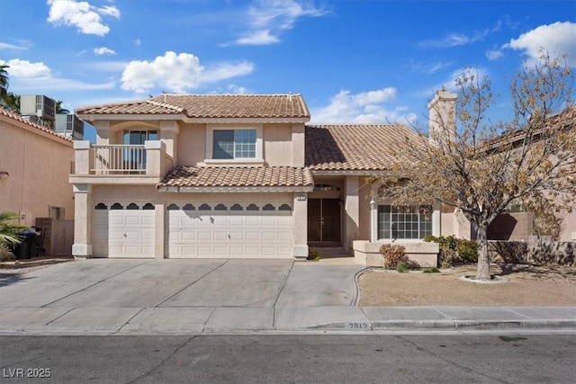 2812 Via Avanti St, Henderson, NV 89074 - mediterranean / spanish home with stucco siding, a tile roof, an attached garage, and concrete driveway