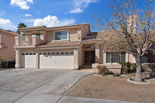 2812 Via Avanti St, Henderson, NV 89074 - view of front facade featuring a tiled roof, stucco siding, an attached garage, concrete driveway, and a balcony