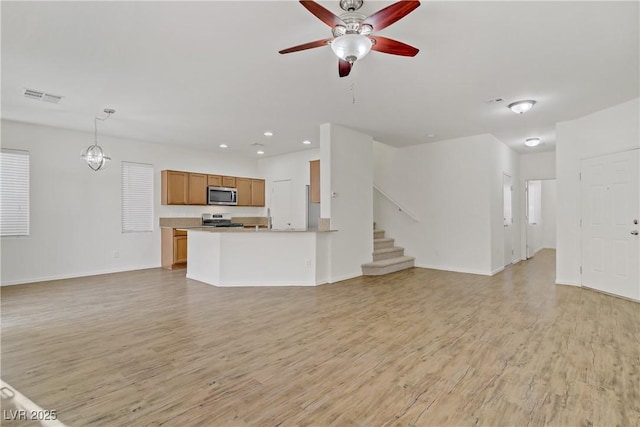 9535 Stills Way, Las Vegas, NV 89148 - unfurnished living room featuring light wood-style floors, recessed lighting, baseboards, ceiling fan, and stairs