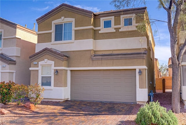 9535 Stills Way, Las Vegas, NV 89148 - view of front of property featuring an attached garage, stucco siding, and decorative driveway