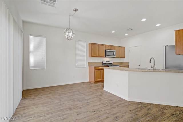 9535 Stills Way, Las Vegas, NV 89148 - kitchen featuring appliances with stainless steel finishes, a sink, light wood-type flooring, light countertops, and recessed lighting