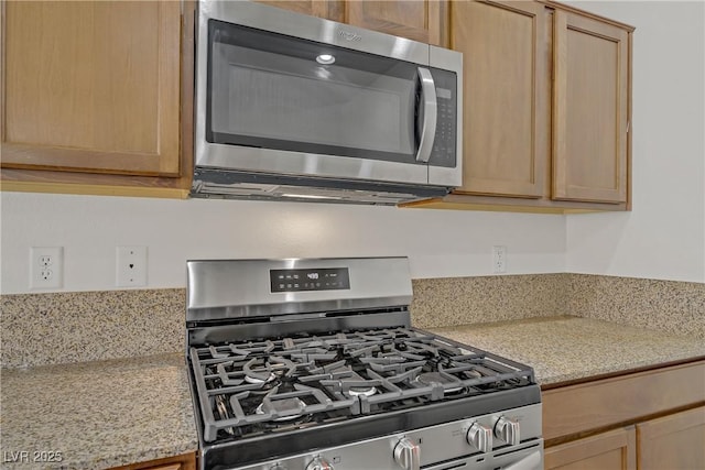 9535 Stills Way, Las Vegas, NV 89148 - kitchen featuring appliances with stainless steel finishes, light brown cabinets, and light stone countertops