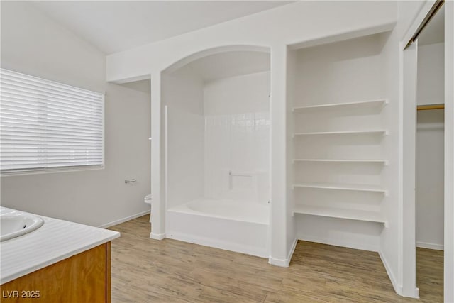 9535 Stills Way, Las Vegas, NV 89148 - bathroom with vanity, wood finished floors, baseboards, toilet, and a walk in closet