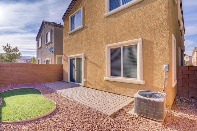 9535 Stills Way, Las Vegas, NV 89148 - back of property featuring cooling unit, stucco siding, a fenced backyard, and a patio