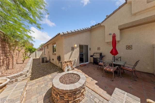 9393 New Utrecht St, Las Vegas, NV 89178 - fenced backyard with a patio area, a grill, cooling unit, and a fire pit