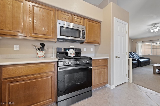 9393 New Utrecht St, Las Vegas, NV 89178 - kitchen featuring appliances with stainless steel finishes, light tile patterned flooring, light countertops, and ceiling fan