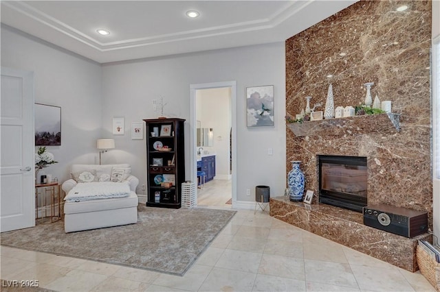 2111 Bogart Ct, Las Vegas, NV 89117 - living area featuring a high end fireplace, a tray ceiling, baseboards, and recessed lighting