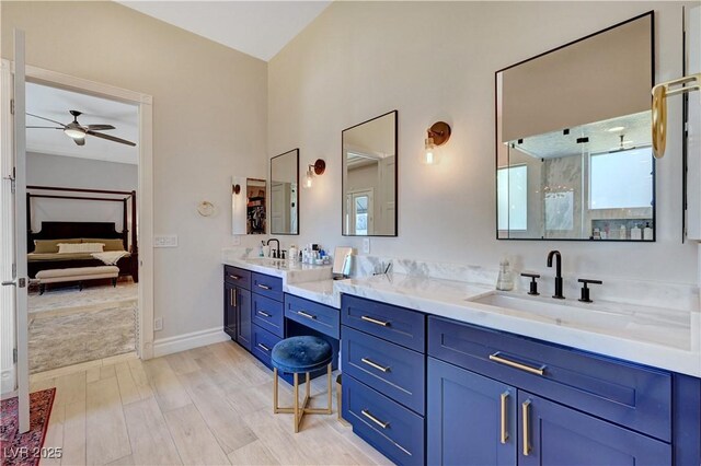 2111 Bogart Ct, Las Vegas, NV 89117 - full bath featuring ensuite bathroom, double vanity, ceiling fan, wood finished floors, and baseboards