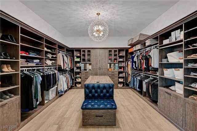 2111 Bogart Ct, Las Vegas, NV 89117 - walk in closet featuring a chandelier and light wood-style flooring