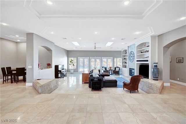 2111 Bogart Ct, Las Vegas, NV 89117 - living area featuring built in features, arched walkways, baseboards, recessed lighting, and a skylight