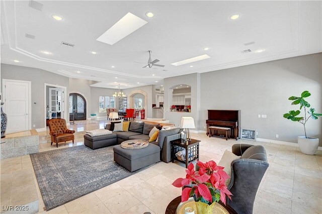 2111 Bogart Ct, Las Vegas, NV 89117 - living room with a skylight, arched walkways, recessed lighting, a ceiling fan, and baseboards