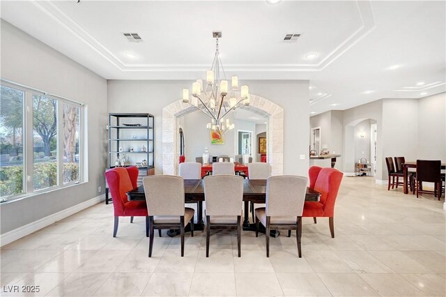 2111 Bogart Ct, Las Vegas, NV 89117 - dining room with arched walkways, a chandelier, a raised ceiling, baseboards, and light tile patterned floors