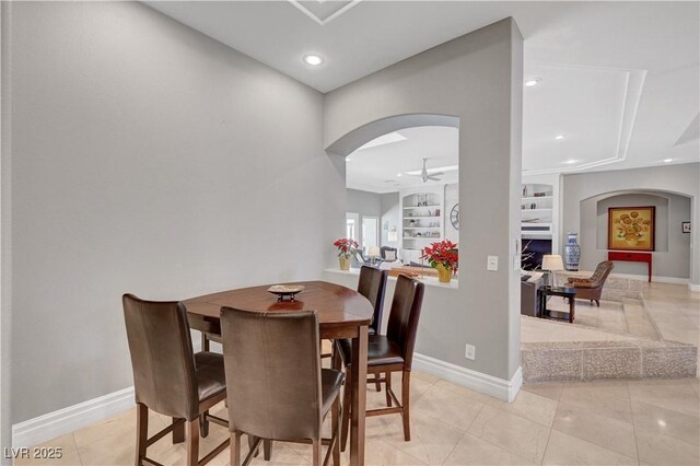 2111 Bogart Ct, Las Vegas, NV 89117 - dining area featuring arched walkways, recessed lighting, ceiling fan, baseboards, and a fireplace