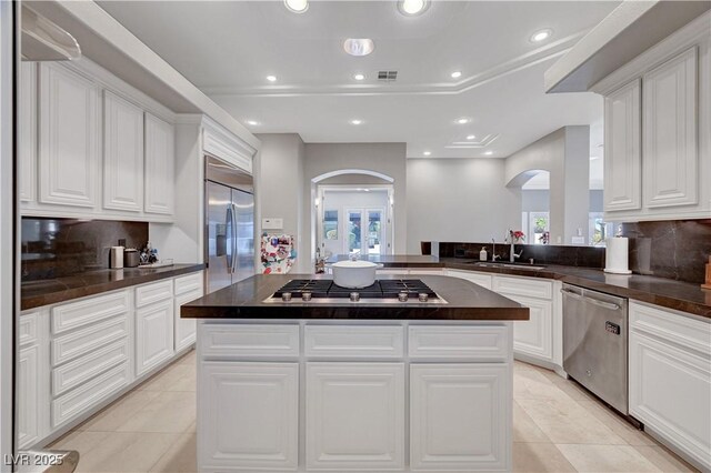 2111 Bogart Ct, Las Vegas, NV 89117 - kitchen featuring arched walkways, appliances with stainless steel finishes, a sink, a kitchen island, and recessed lighting