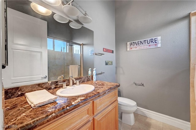 2111 Bogart Ct, Las Vegas, NV 89117 - bathroom with toilet, vanity, tile patterned floors, baseboards, and a shower with door