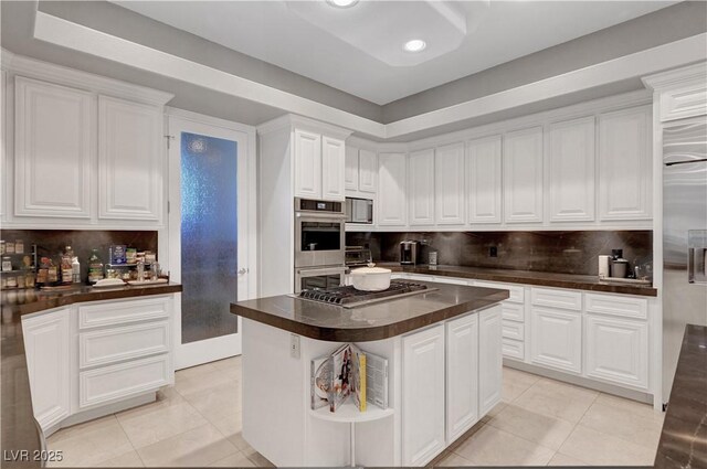 2111 Bogart Ct, Las Vegas, NV 89117 - kitchen with appliances with stainless steel finishes, light tile patterned flooring, white cabinetry, backsplash, and recessed lighting